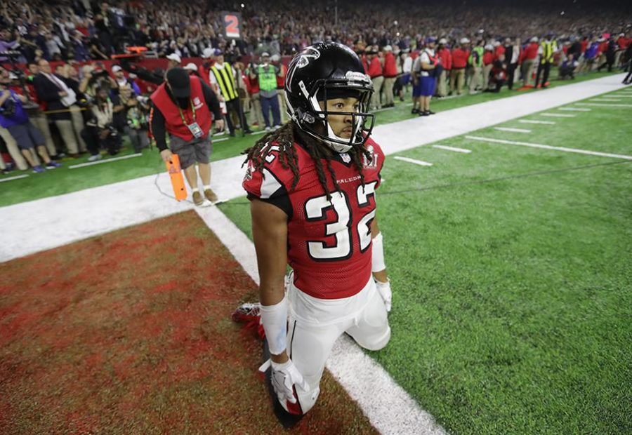 Atlanta Falcons cornerback Jalen Collins kneels in shock after the New England Patriots defeat the Falcons 34-28 in overtime at the Super Bowl (AJC).