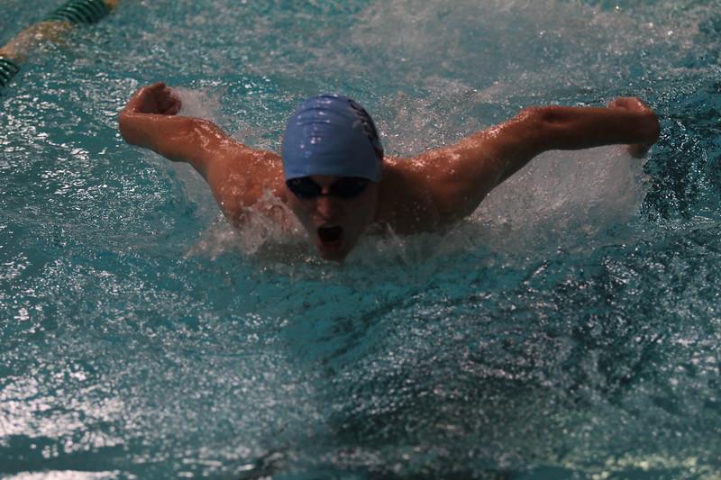 A member of the Cambridge Swim and Dive team seen here swimming as fast as he can in order to come out victorious.