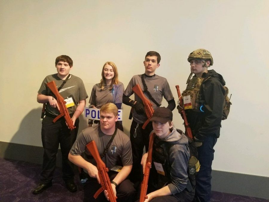 The tactical team in uniform, posing with their equipment.
