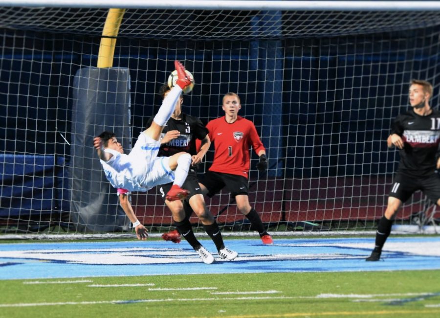 Ramirez goes flying in the air to score a goal against Lambert.      