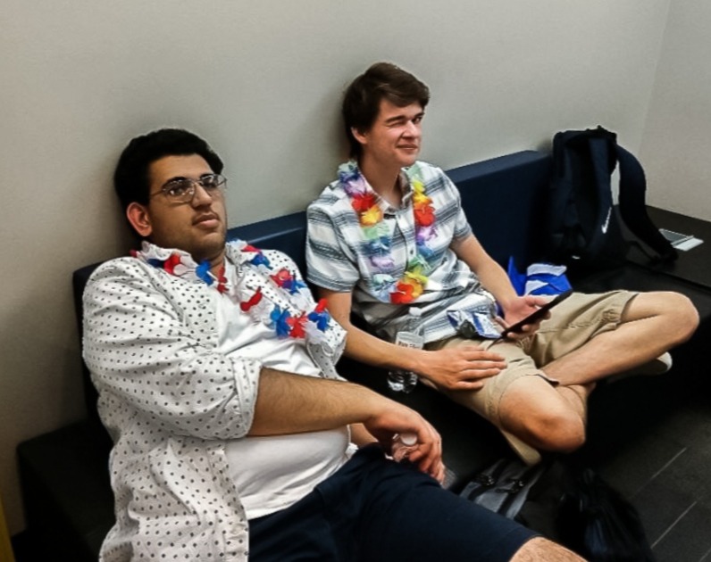 Senior debaters Ayush Kumar (left) and Logan Sowder (right) in their debate attire: leis and Hawaiian shirts