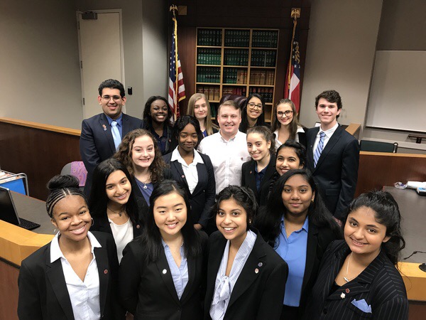 Members of the mock trial team, along with attorney coach Chris Howard.