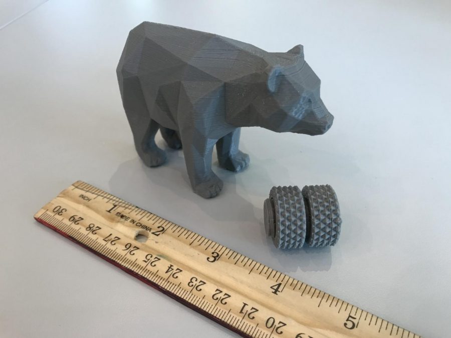 A plastic bear (roughly 2 x 3 x 2 in) made by the 3D printer.