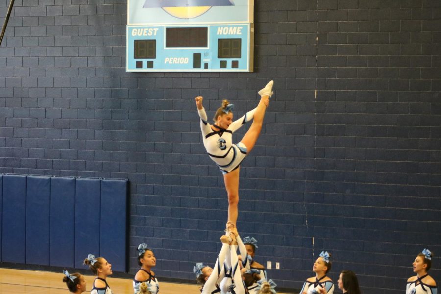 Freshman flyer Sam Smith performing a stunt during cheer practice.