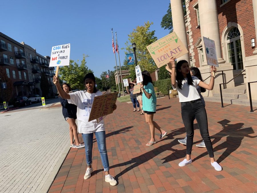 Students display homemade signs as they protest towards oncoming traffic. 