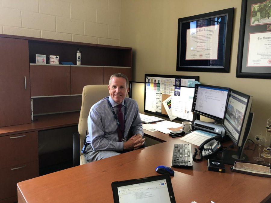 New assistant principal David Goldie in his  office, surrounded by his accolades and Cambridge memorabilia.