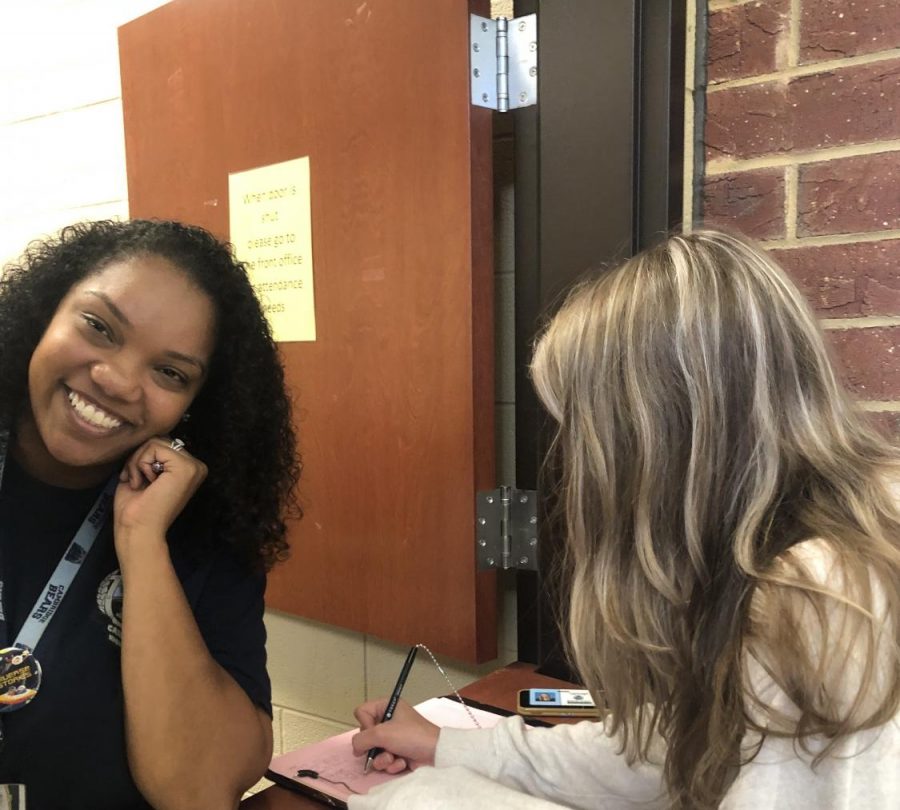 Junior Sylvie Huss signs into the attendance office.