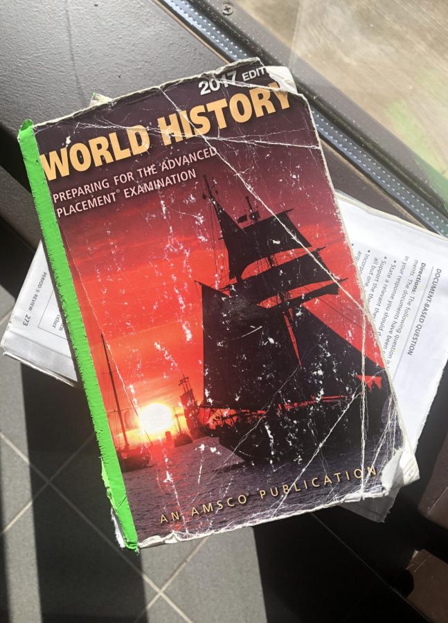 An illustrated photo of a 2017 edition AP World History book, nicknamed the AMSCO, ripped in half. 