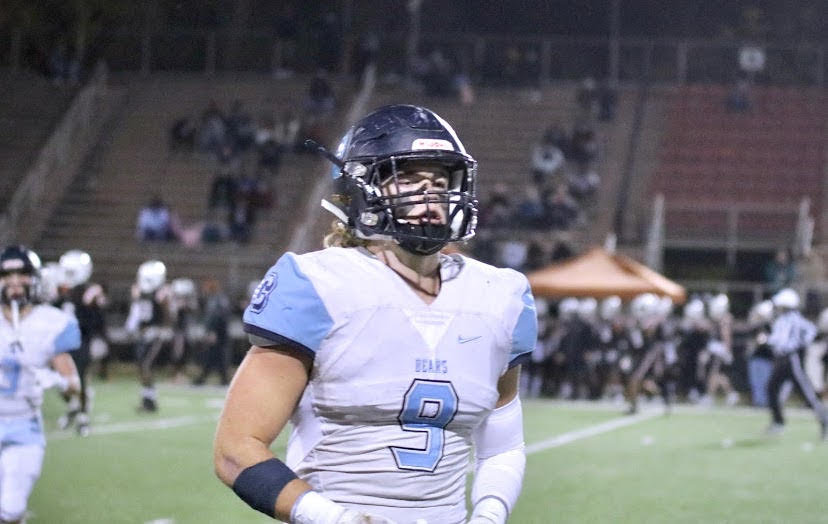 Senior linebacker, Luke Ritter, walking across the field. 