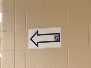 Blue arrows guide students' paths throughout the halls.