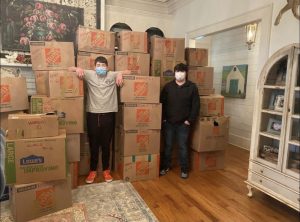Moeller (left) and Parry (right) standing next to their shoe donation collection. 