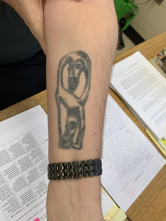“This is a central African statue piece,” English teacher Jon Karschnik said of his tattoo. “I always thought it looked like the comedy and tragedy masks.” 