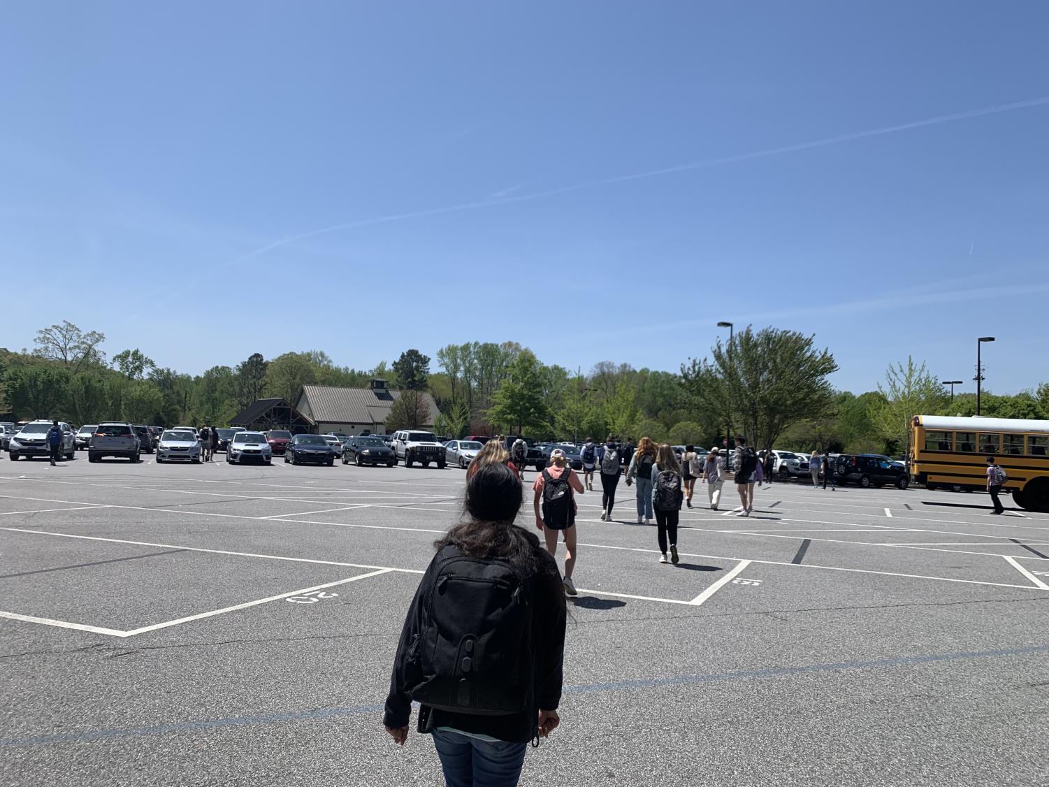 Many students who have virtual afternoon classes leave in the middle of the day. Seen here, students walk to their cars after fourth period.