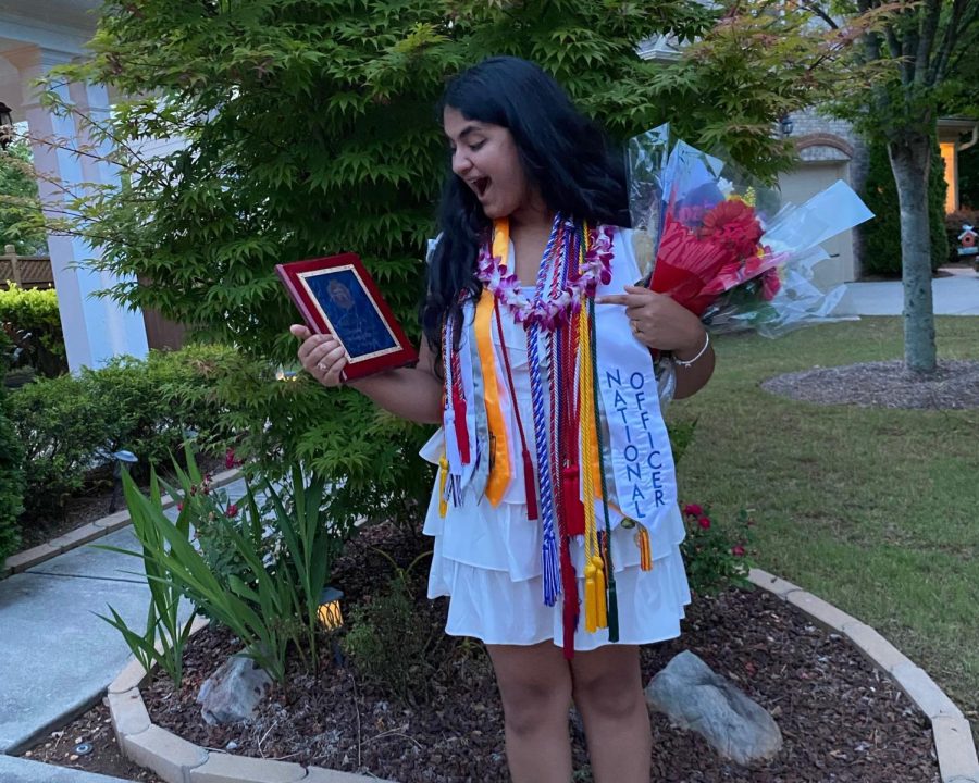 Sharma+after+her+graduation+ceremony%2C+decked+out+in+cords+and+holding+her+Principals+Award.