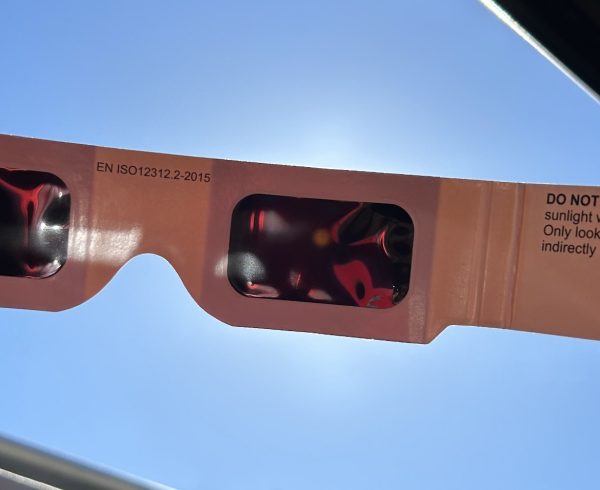 The sun through a pair of solar eclipse glasses.