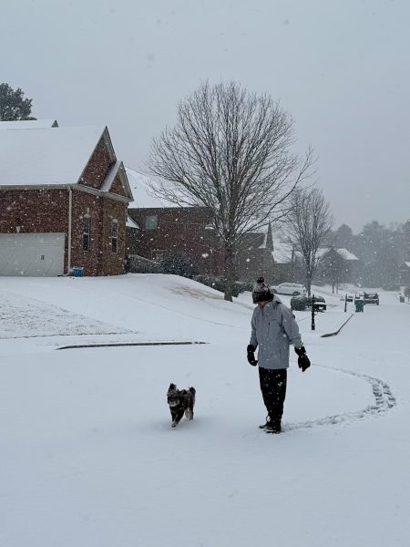 Freshman Sebastian Perolta walking in the snow with his dog. 